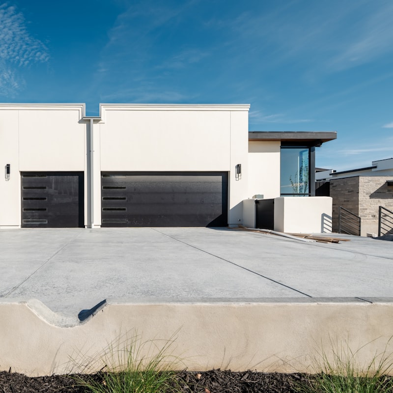 Two homes with cleaned driveways and garage doors