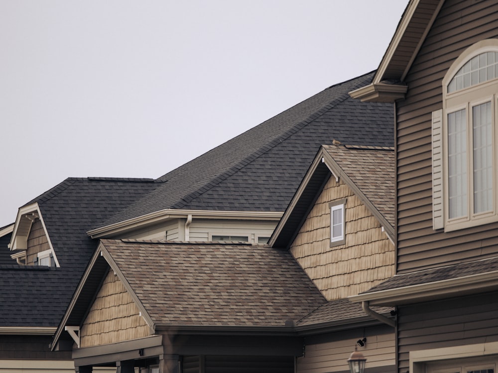 Close view of clean asphalt shingle roof planes and dormers